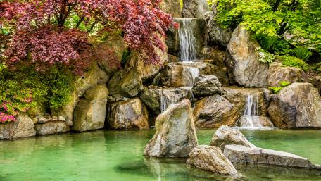 Tranquil Waterfall in Lush Garden wallpaper