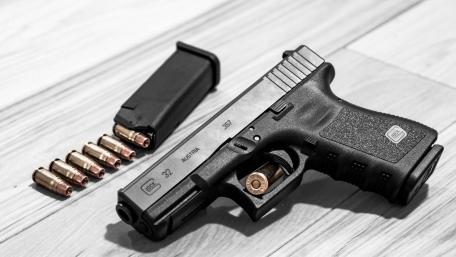 Sleek Handgun and Bullets Ready for Action wallpaper