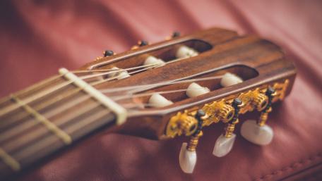 guitar fretboard strings in gold wallpaper
