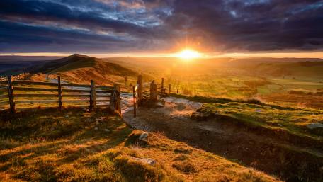 Golden Sunrise Over Highland Horizon wallpaper