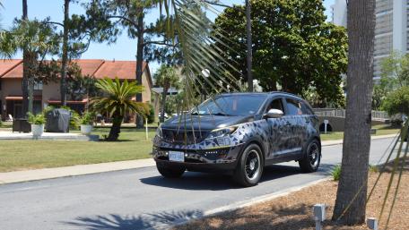 Stylish Kia SUV on a Vibrant Street Scene wallpaper