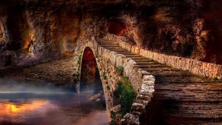 Serene Stone Bridge Over Tranquil Waters wallpaper