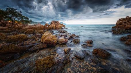Dramatic Coastal Scene Under Cloudy Sky wallpaper