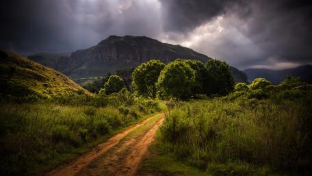 Serene Pathway Through Majestic Highlands wallpaper