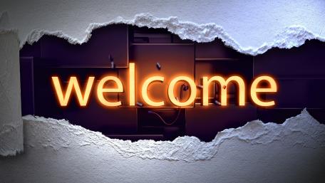 Glowing Welcome Neon Sign Illuminates the Wall wallpaper