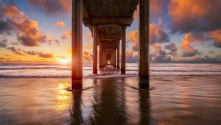 Serene Sunset Beneath the Pier wallpaper