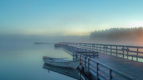 White boat on the foggy lake wallpaper