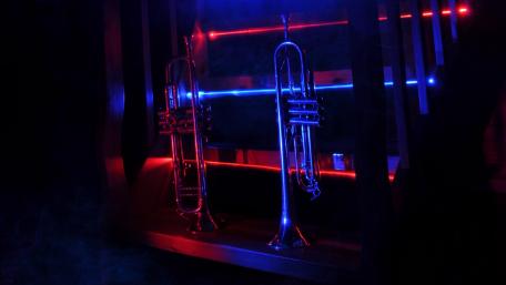 Trumpet Stage Illuminated in Blue and Red Lights wallpaper