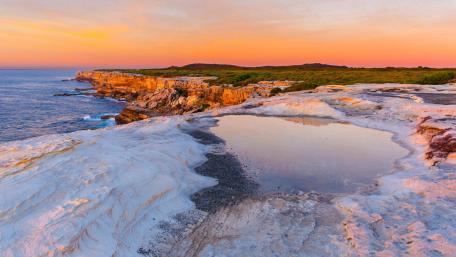Rocky lake with ocean view wallpaper