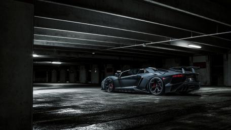 Sleek and Bold Black Lamborghini in Urban Environment wallpaper
