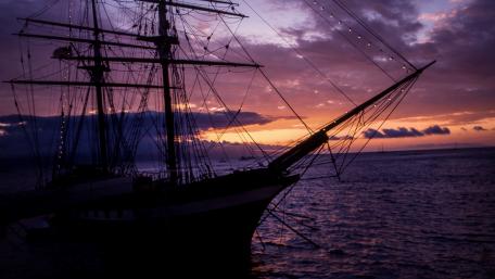 Majestic Tall Ship Against Purple Sunset wallpaper
