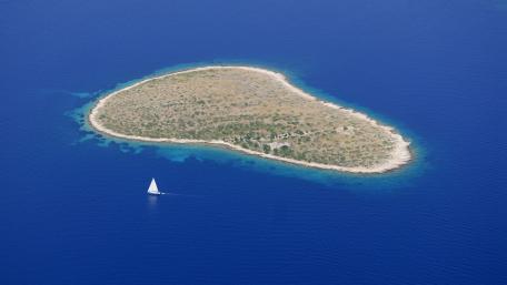 Tranquil Islet Surrounded by Deep Blue Sea wallpaper