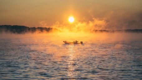 Boat on the misty lake wallpaper