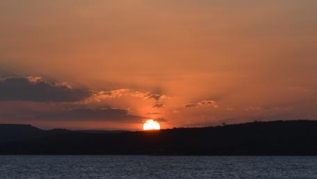 Breathtaking Brazilian Sunset Over Water wallpaper