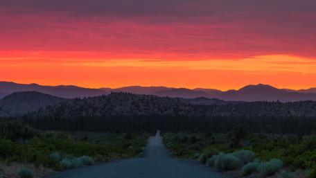 Breathtaking Sunset Over Serene Roadway wallpaper