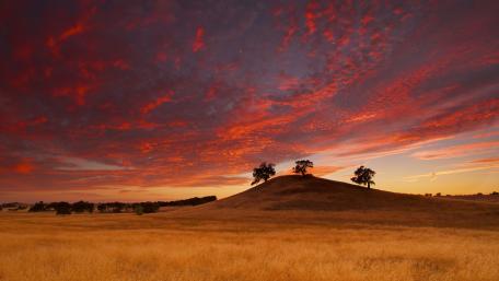 Serene Hills Under a Vibrant Sky wallpaper