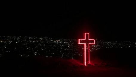 Red light cross above the city wallpaper