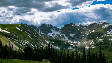 Majestic Mountain Range Under Dramatic Sky wallpaper
