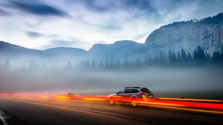 Morning Drive Through Misty Mountains with Light Trails wallpaper
