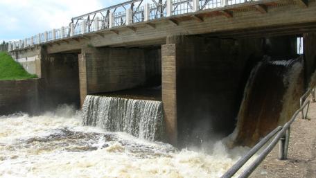 Waterfall Flowing Under Bridge wallpaper