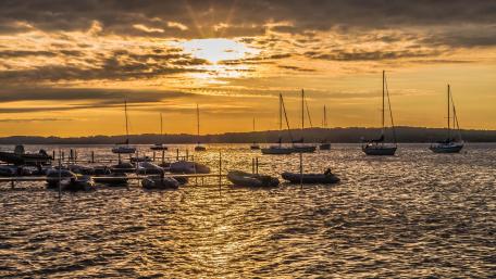 Sailing into the Sunset Over Water wallpaper