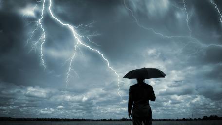Man with umbrella in a storm wallpaper