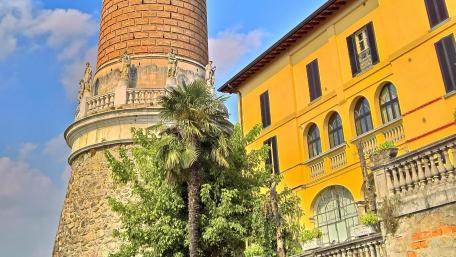 Charming Cityscape with Historical Architecture and Lush Foliage wallpaper