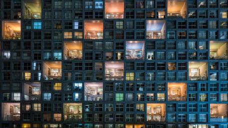 Urban Mosaic: Illuminated Windows of Nightlife wallpaper