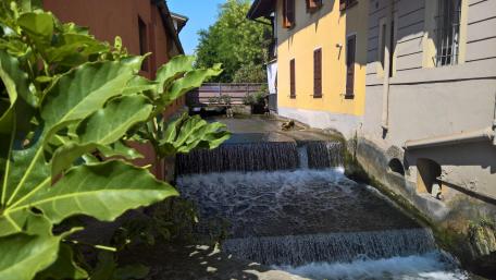 Tranquil Waterfall in Urban Setting wallpaper