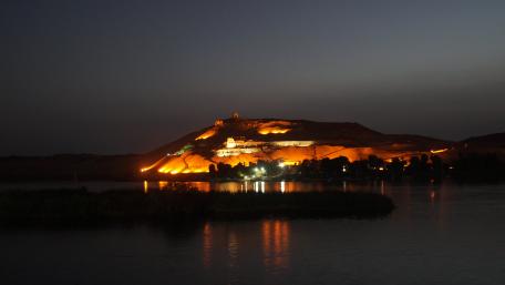 Serene Nile River at Night Illuminated by Hillside Lights wallpaper