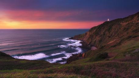 Serene Sunset Over Coastal Cliffs and Waves wallpaper