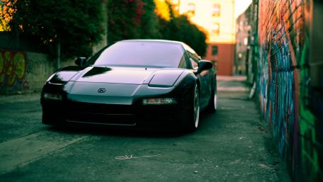 Sleek Black Sports Car in Urban Setting wallpaper