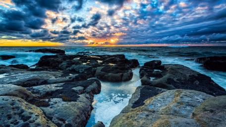Ocean’s Edge at Sunset with Dramatic Skies wallpaper