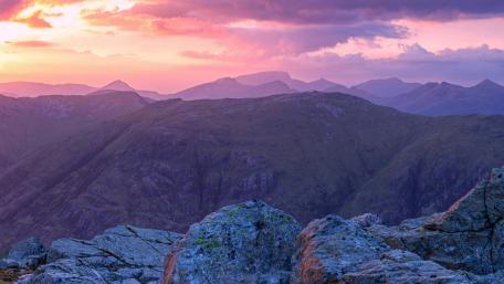 Majestic Purple Sunset over Rugged Mountains wallpaper