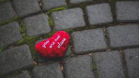 Heart on mossy pavement wallpaper