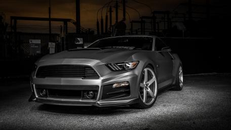 Sleek Muscle Car Under Dramatic Lighting wallpaper