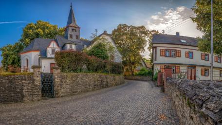 Cobblestone street to church wallpaper