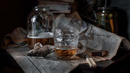 Fish and beer on a newspaper wallpaper
