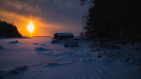 House at a frozen lake wallpaper
