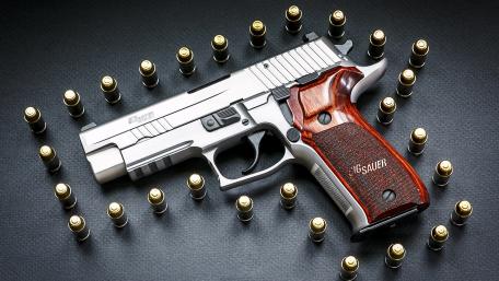 Stainless Steel Handgun Surrounded by Bullets wallpaper