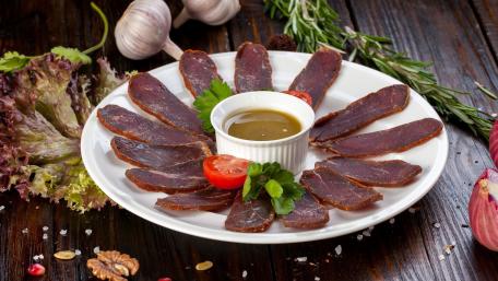 Savory Meat Appetizer Platter Delightful Presentation of Flavorful Slices wallpaper