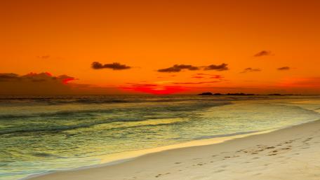 Fiery Sunset Over Tranquil Beach Scene wallpaper