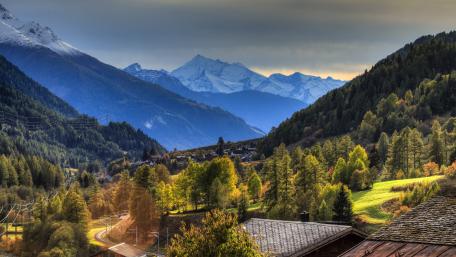 Majestic Mountain Village in Tranquil Valley wallpaper