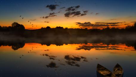 Boat on the lakeside at sunset wallpaper