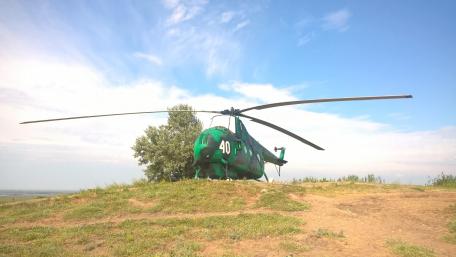 Abandoned Helicopter on a Scenic Hilltop wallpaper