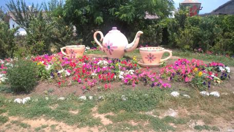 Whimsical Flower Garden with Teapot and Cups wallpaper