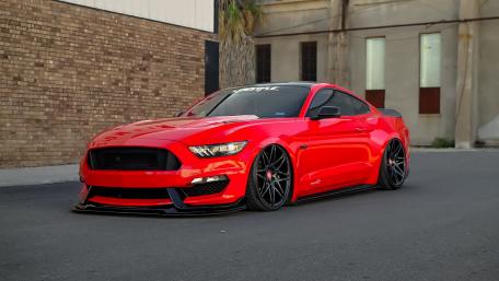 Sleek Red Ford Mustang Muscle Car Wallpaper wallpaper