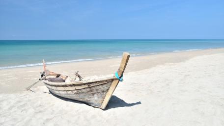 Boat on a sandy beach wallpaper