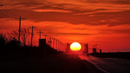 Vibrant Sunset Over Tranquil Roadway wallpaper