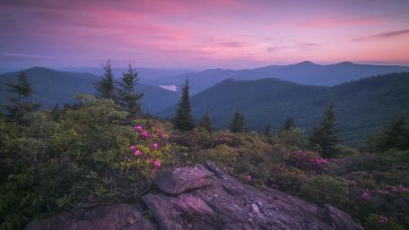 Serene Highland Dawn Over Majestic Mountains wallpaper